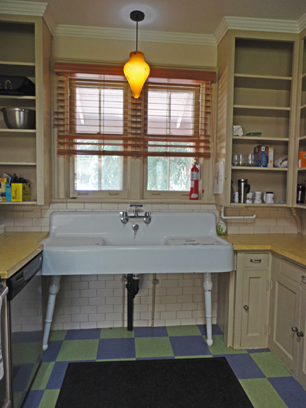 Kitchen confidential a-la- turn of the last century - except for the crazy light fixture. Who's up for some dishes tonight?