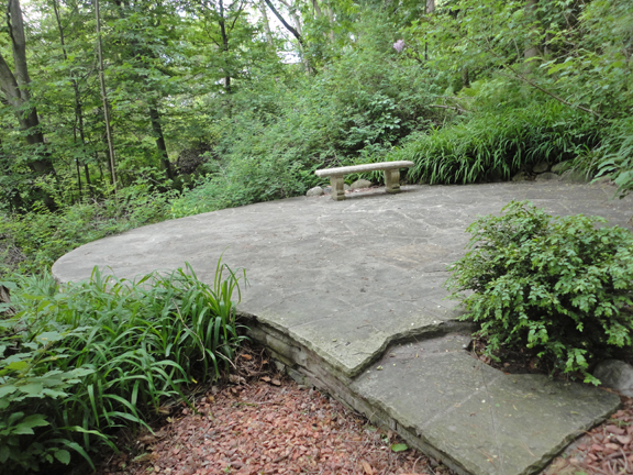 Pausing at one of the valley terraces in this spectacular shady ravine backyard. Lake Ontario is in the background.