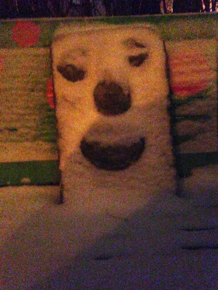 Snow settling in on Burgess Dulaney's concrete face plaque