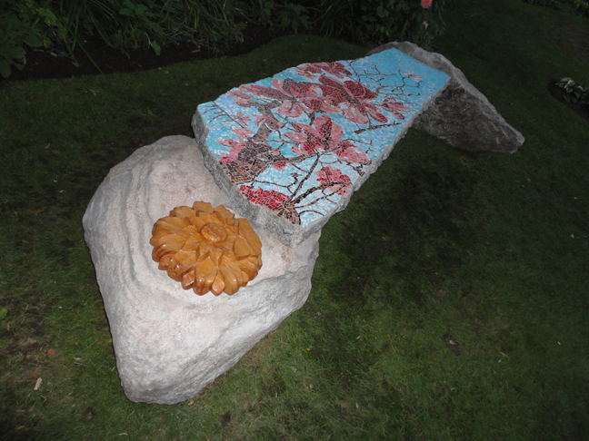 The Magnolia Bench - granite garden bench with Italian Smalti tiles. The wood sculpture was created by Toronto carver Ruth Arnold. 