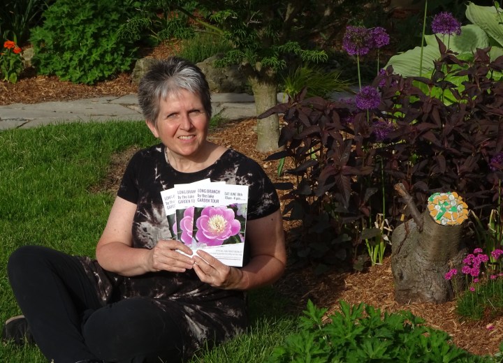 Sheila Gregory with ticket books in Garden.jpg